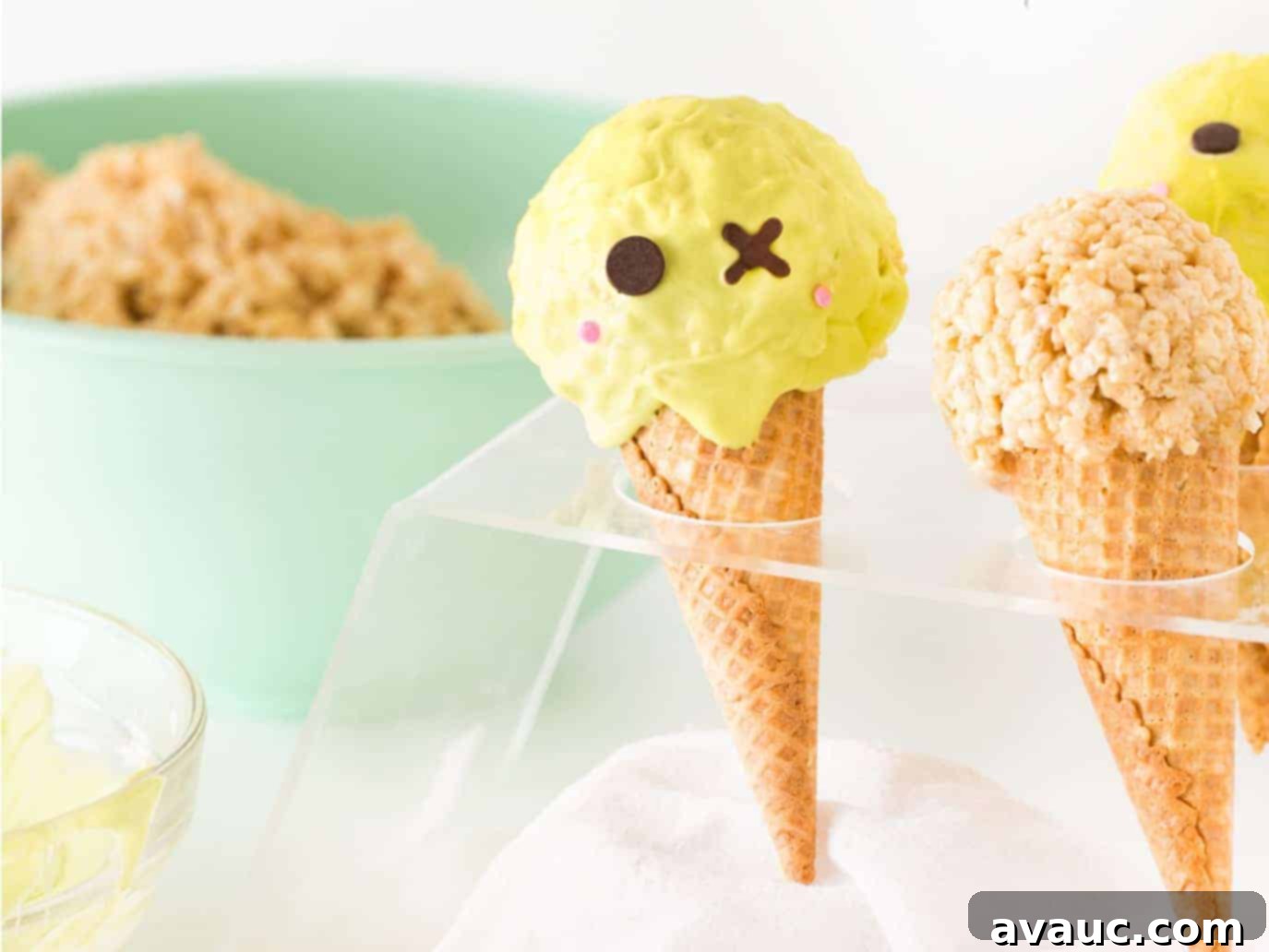 A group of cute Zombie Halloween Rice Krispie Treats artfully arranged in a clear plastic ice cream cone holder, ready for a party.
