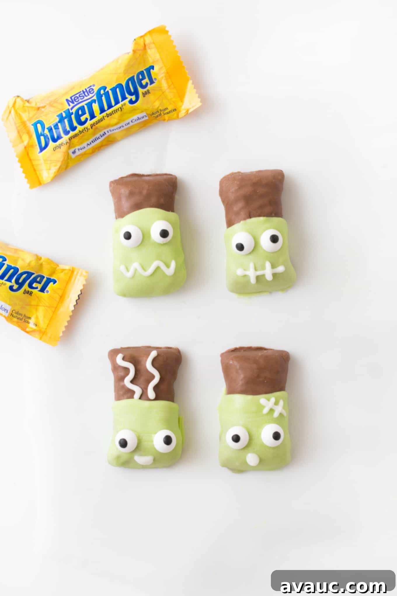 Butterfinger candy bars that have been dipped in melted green almond bark then decorated with candy eyeballs to look like Frankenstein and Frankenstein's bride.