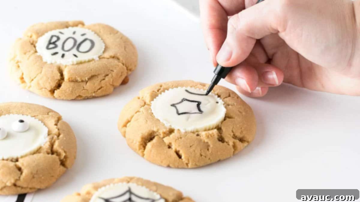 Design Your Own Simple Spooky Cookies 10 Overhead shot of two Halloween peanut butter cup cookies with simple, hand-drawn spooky faces.