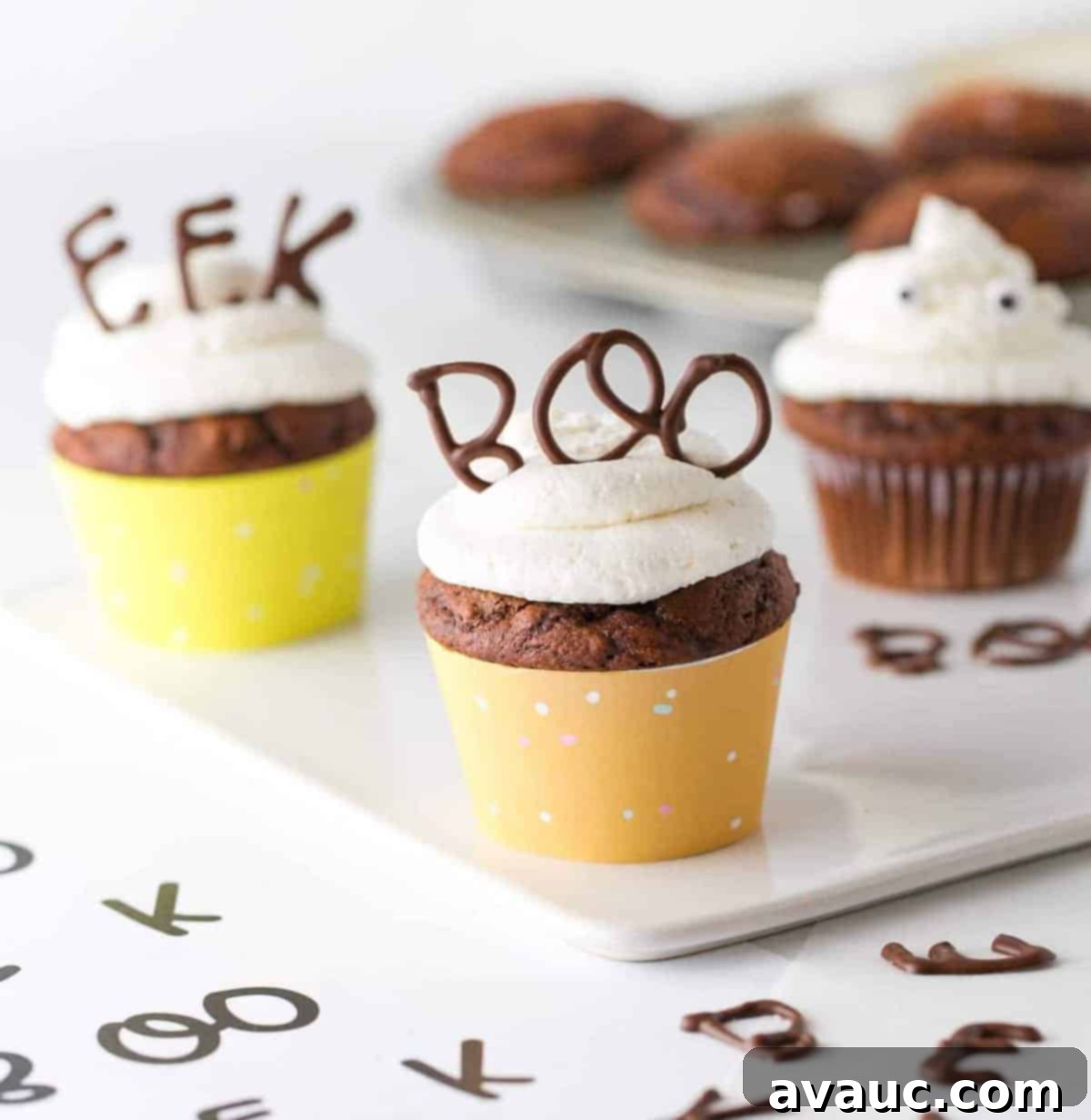 Spooky Edible Cupcake Toppers 6 Chocolate cupcake with vanilla frosting in orange cupcake wrapper. With chocolate BOO word on top for edible Halloween Halloween cupcake topper.