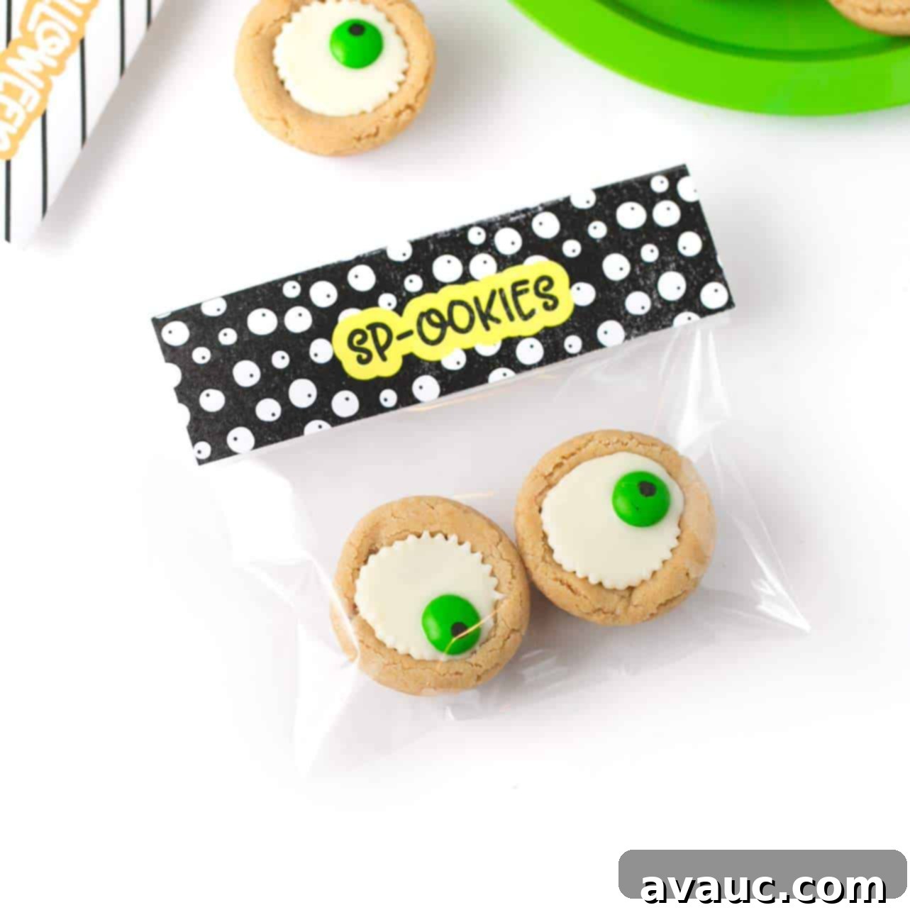 Easy Halloween Eyeball Cookies the kids can help with! After baking, simply press a miniature white peanut butter cup and M&M into the top of each one for a spooky (but cute!) halloween cookie idea.  #Halloween #Cookies #EyeballCookies | www.DesignEatRepeat.com