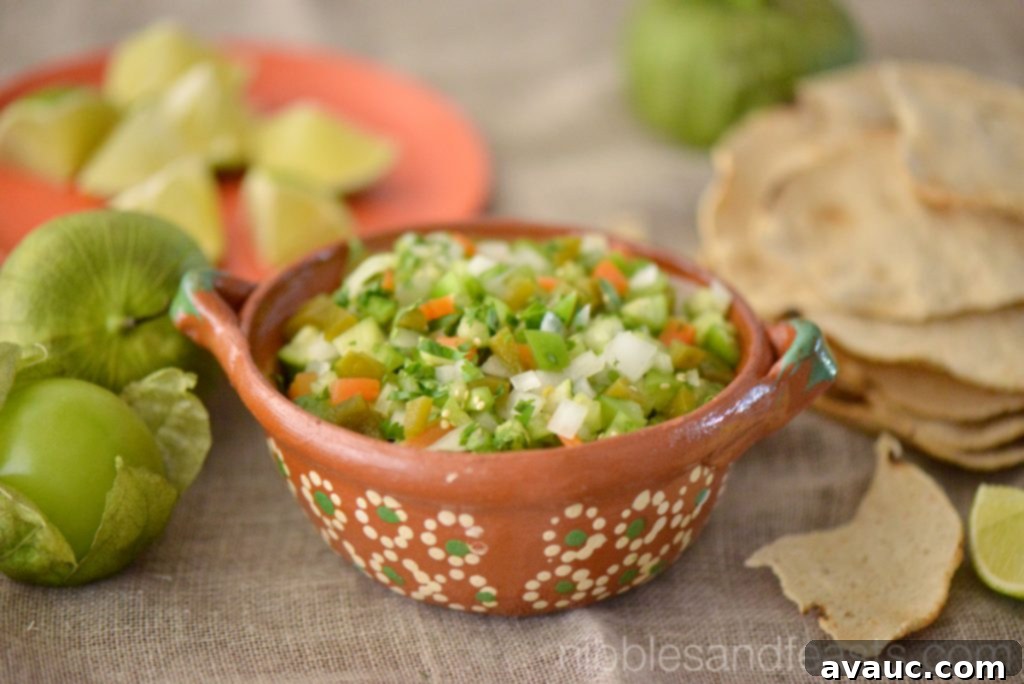 Green Pico de Gallo Verde in a bowl, featuring tomatillos, pickled jalapeños, and pickled carrots.
