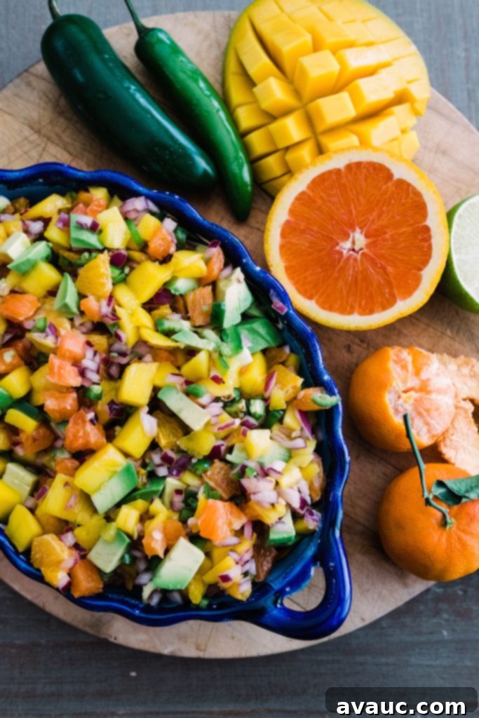 Bowl of colorful Citrus Mango Avocado Salsa with fresh ingredients like mango, avocado, red onion, and cilantro.