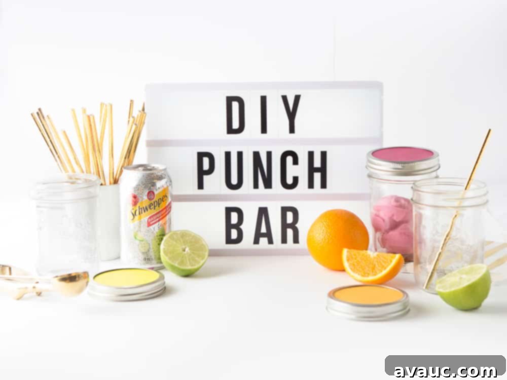 A white lightbox sign with words, "DIY Punch Bar" surrounded by cans of Schweppes sparkling water, mason jars, gold straws, and slices of fresh fruit.
