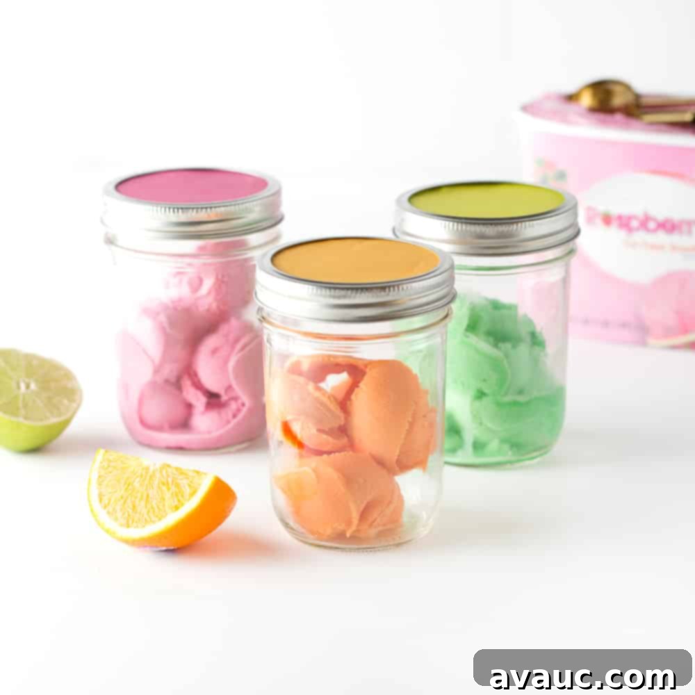 Scoops of raspberry, orange, and lime sherbet in mason jars, ready for guests to create their DIY punch bar drinks.