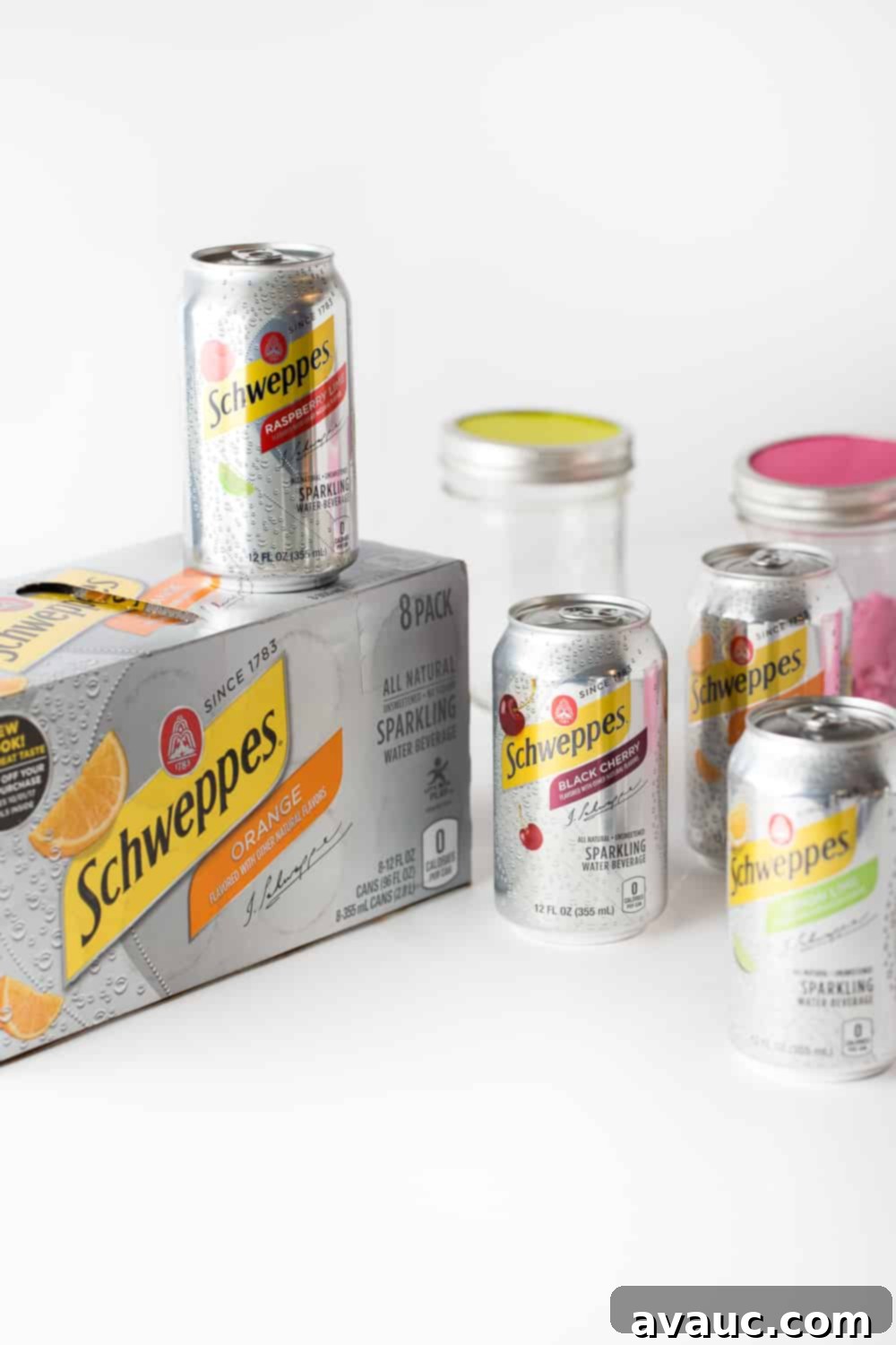 Cans of various Schweppes Sparkling Water flavors arranged, ready to be used for a DIY Punch Bar.