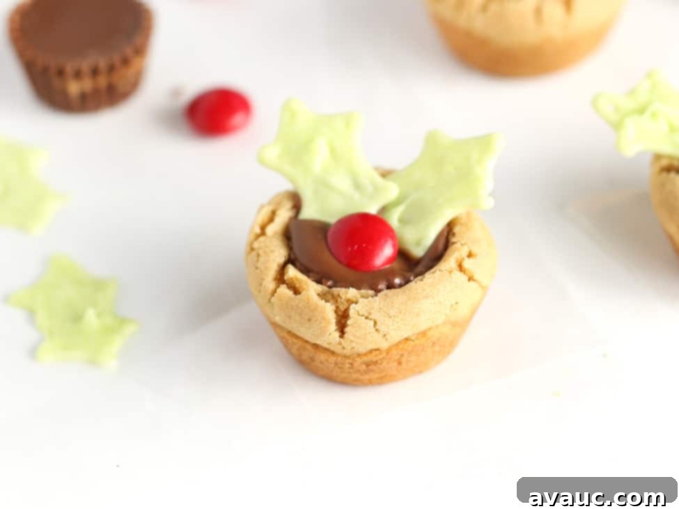 Holly Jolly Cookie Cups 14 Reeses peanut butter cup cookie decorated like holly leaf to make easy Christmas holly cookie cups.