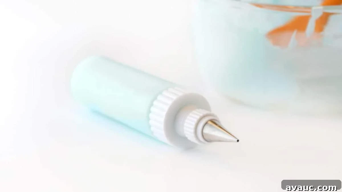 Decorating bottle of blue cookie icing with #2 piping tip.