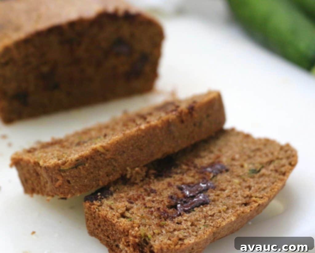 Slice of whole wheat maple zucchini bread with visible dark chocolate chunks