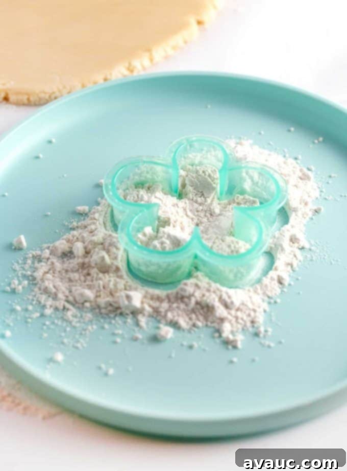 Mastering Flawless Cut Out Sugar Cookies 13 Flower cookie cutter being dipped in flour to prevent sticking for clean cuts