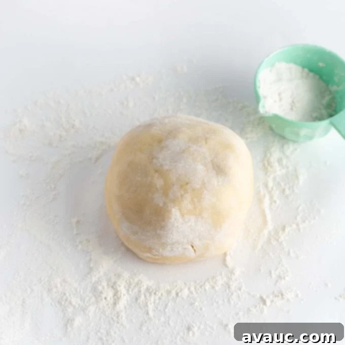 Mastering Flawless Cut Out Sugar Cookies 9 Hands gently kneading and shaping sugar cookie dough into a smooth ball