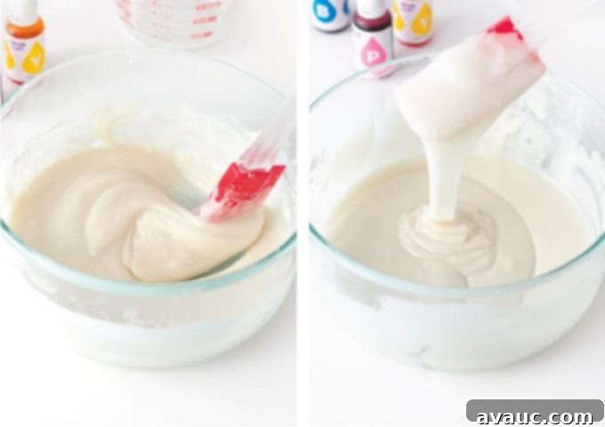 A rubber spatula actively mixing powdered sugar icing in a bowl, showing the creamy texture being formed.