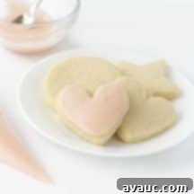 A beautifully iced cookie with powdered sugar icing, showcasing the perfect glaze.
