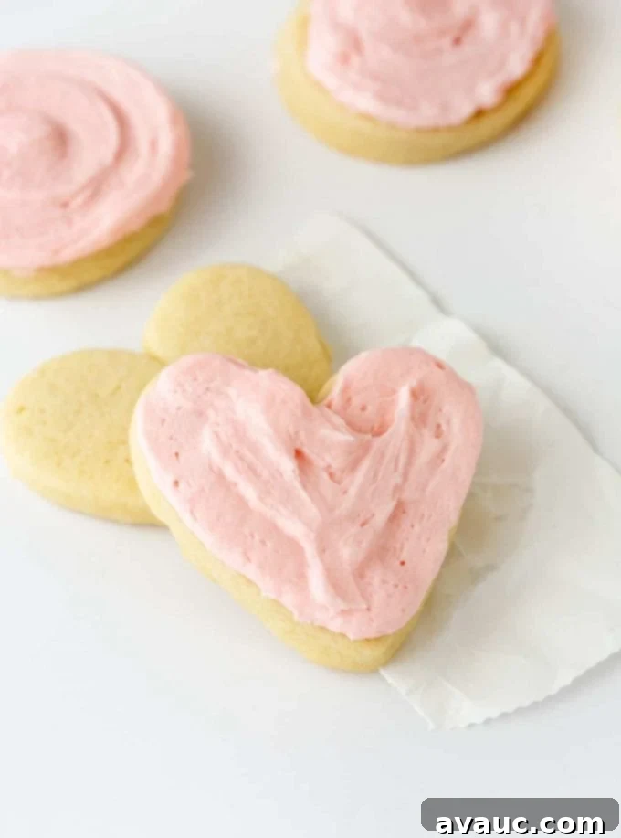 Pink heart-shaped sugar cookies with fluffy buttercream frosting