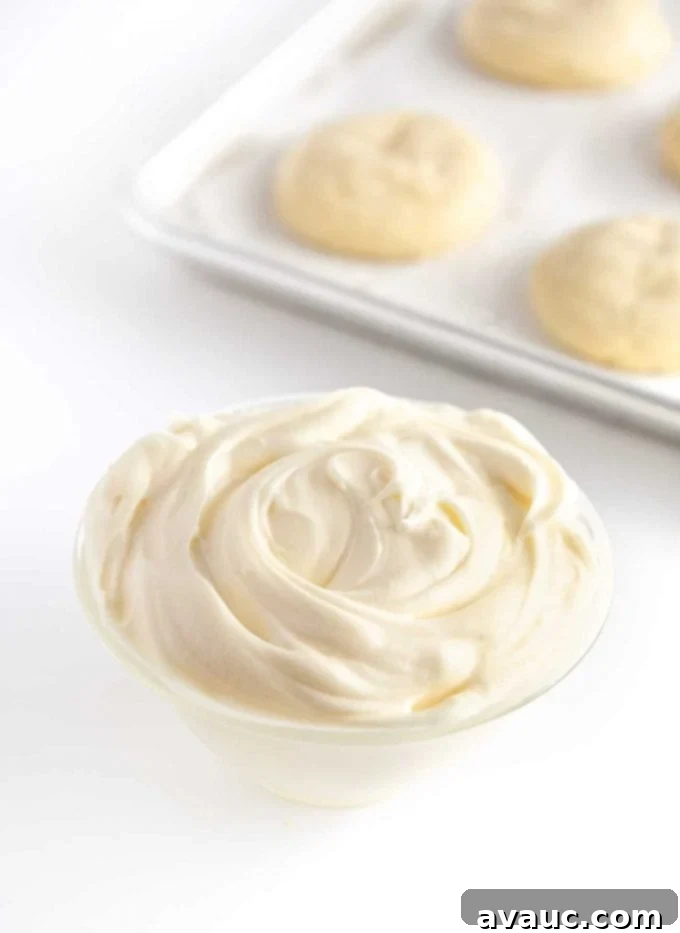 Bowl of white cream cheese frosting for sugar cookies