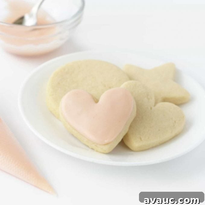 Plate of sugar cookies with a pink heart shaped cookie