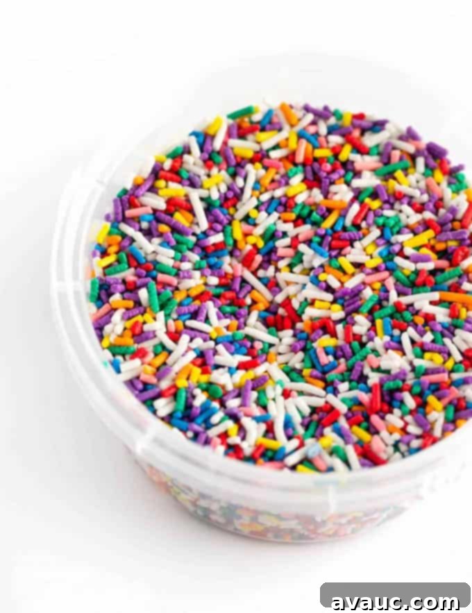 Container of colorful rainbow sprinkles