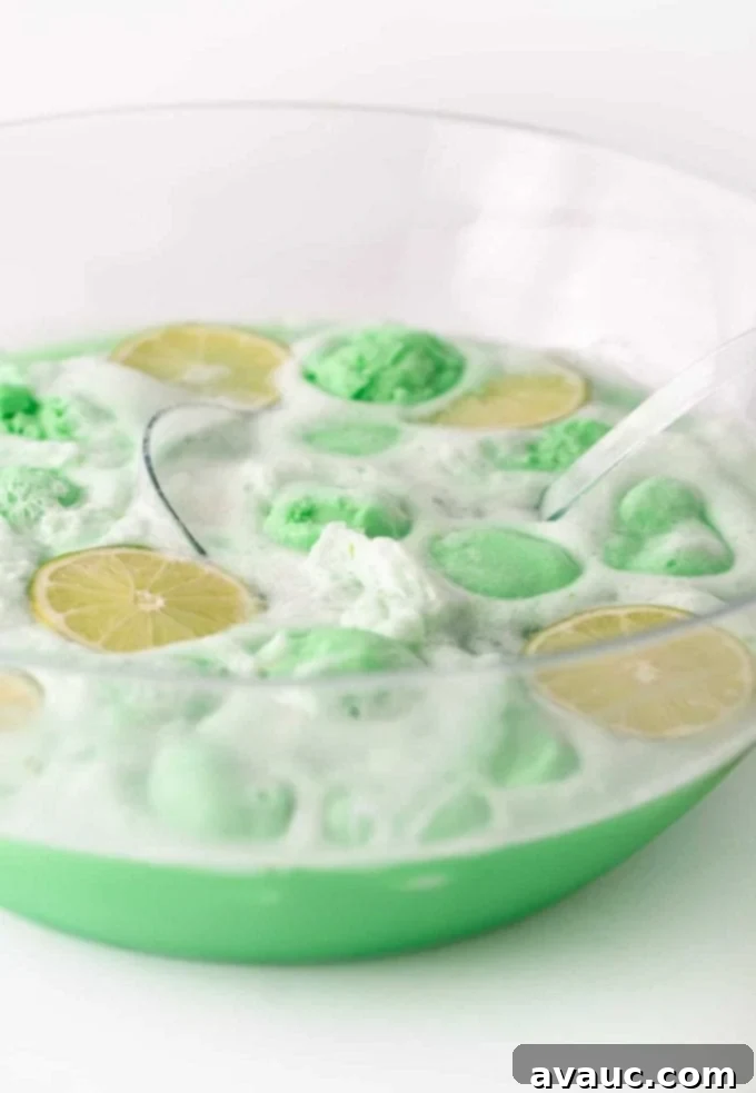 Lime sherbet punch served in glasses with lime slices.