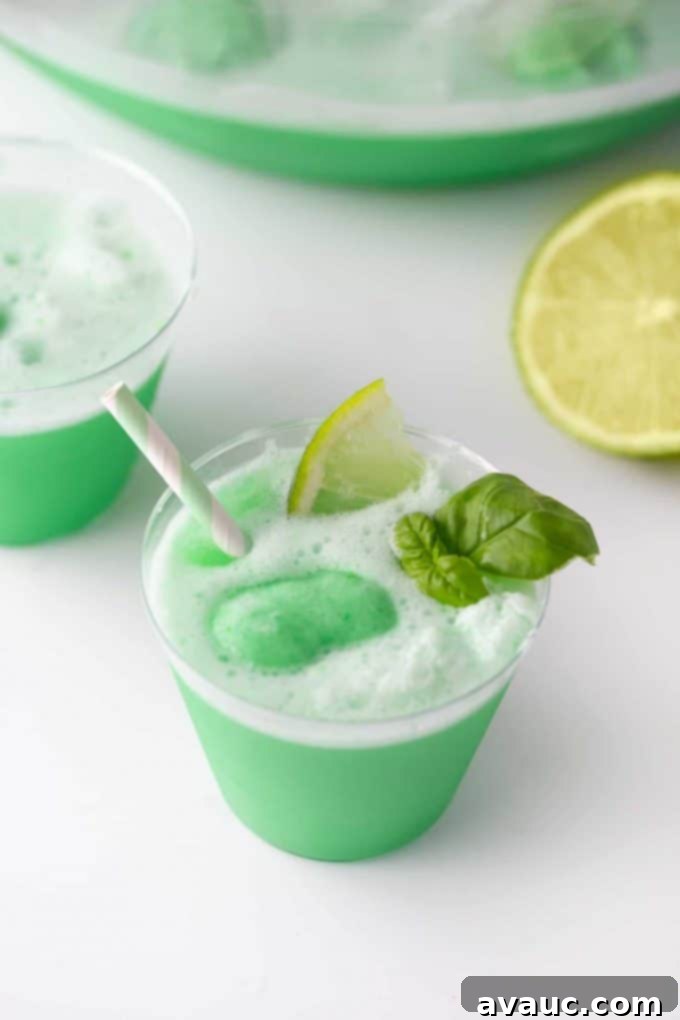 Close-up of lime sherbet punch with scoops of sherbet floating on top, showing its frothy texture.
