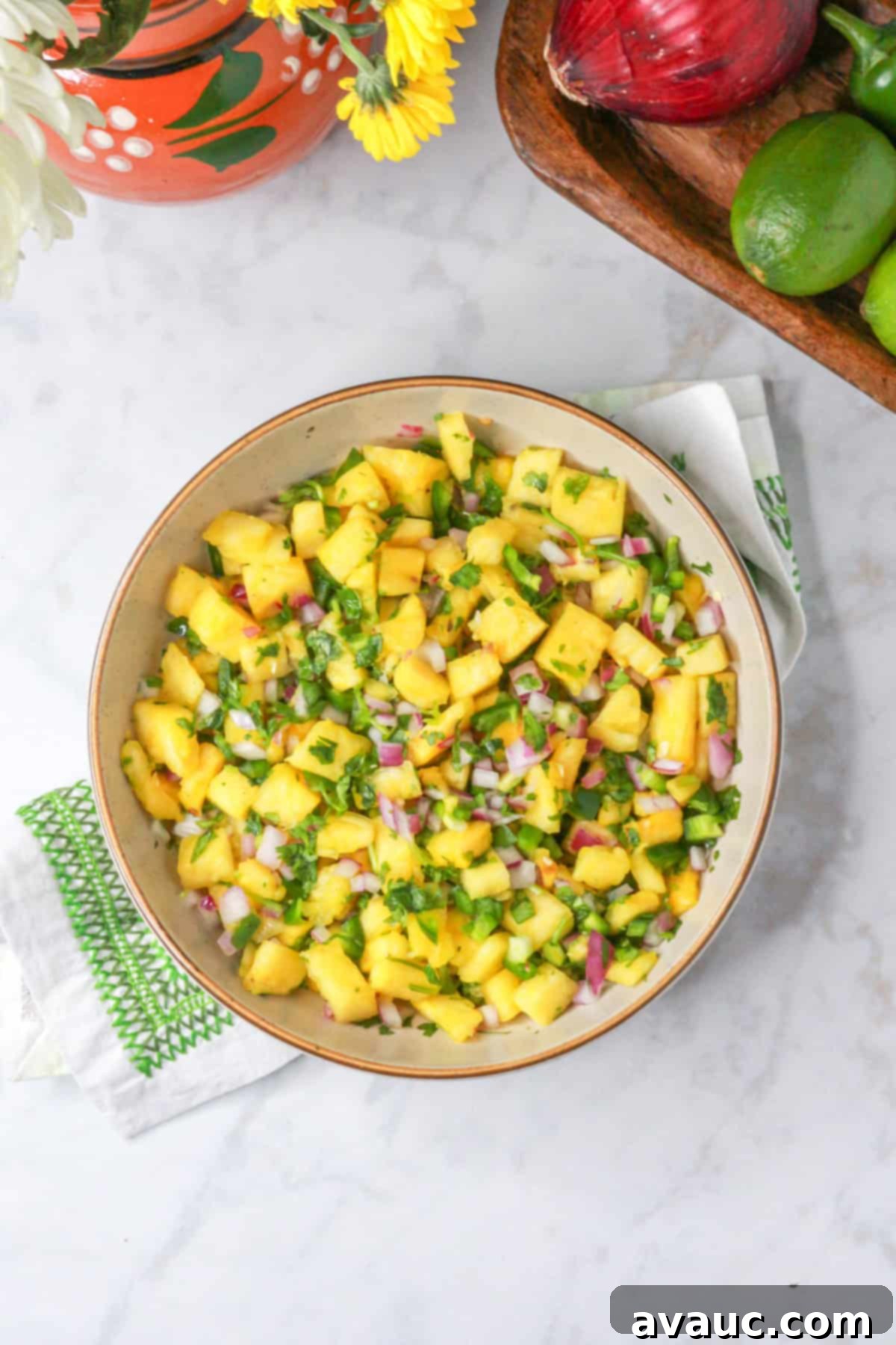 Sweet Heat Pineapple Jalapeño Salsa 2 Above shot of bowl with spicy pineapple jalapeño salsa with ingredients behind it