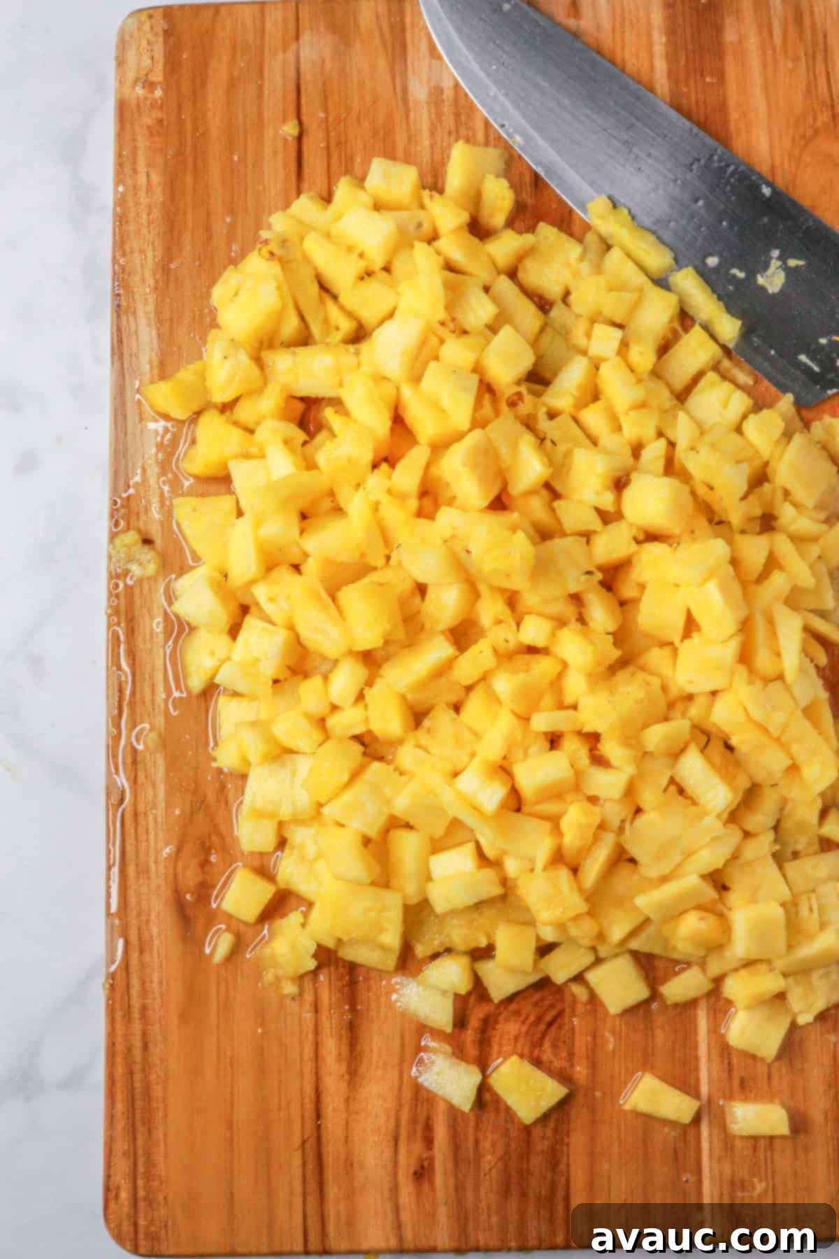 Sweet Heat Pineapple Jalapeño Salsa 5 Diced pineapple on a wood cutting board