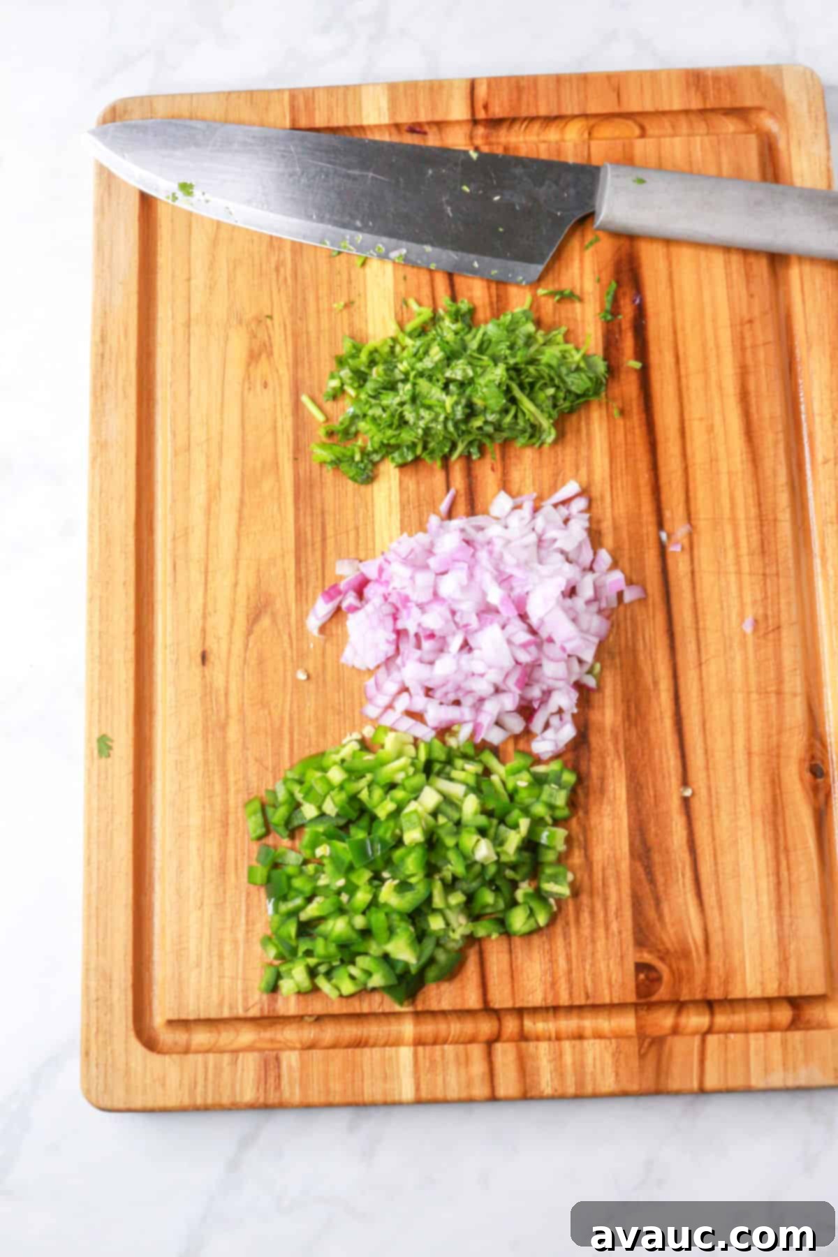 Sweet Heat Pineapple Jalapeño Salsa 6 Diced red onion, jalapeño and cilantro on a wood cutting board