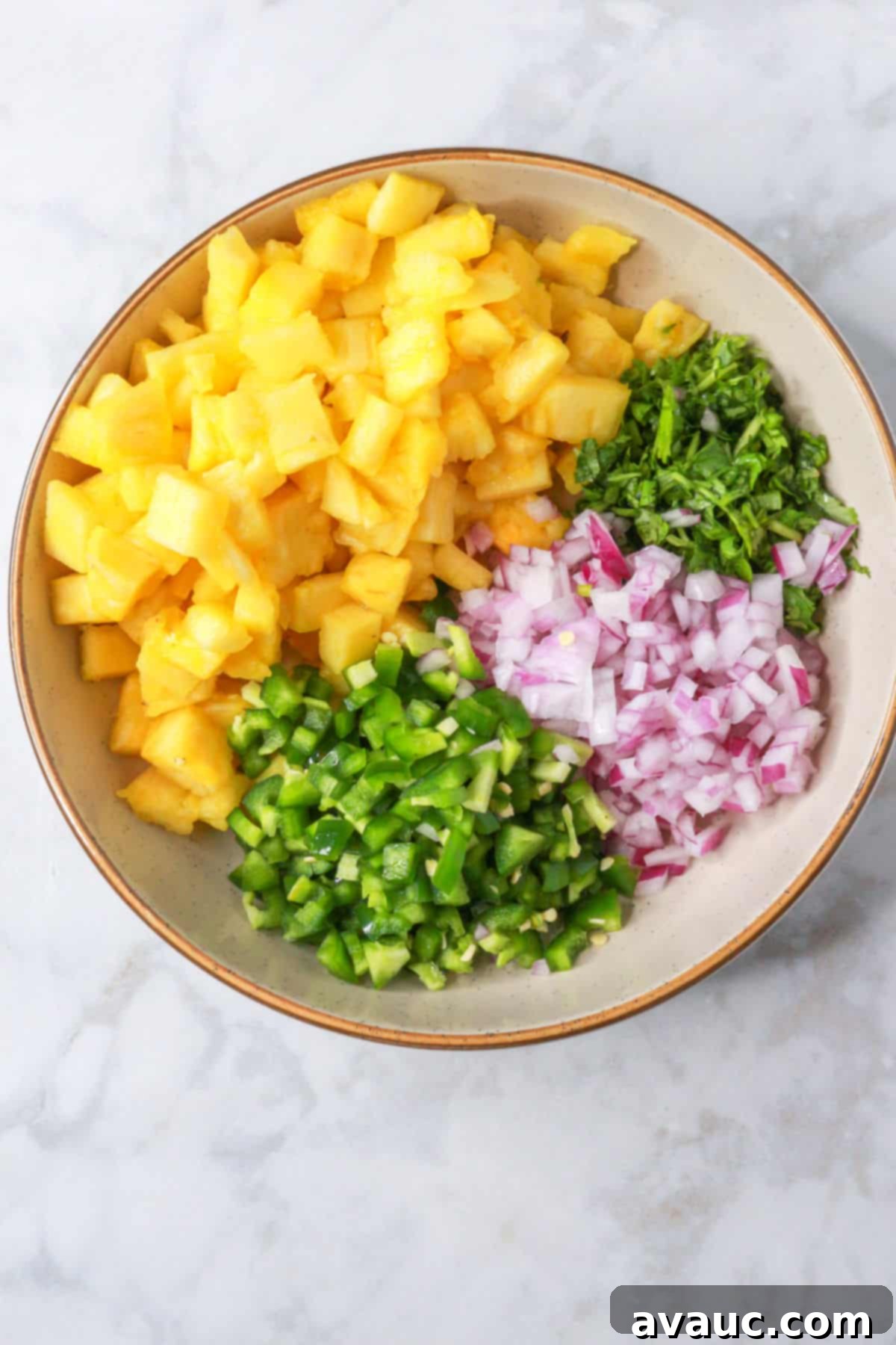 Sweet Heat Pineapple Jalapeño Salsa 7 Diced ingredients for pineapple salsa in a bowl