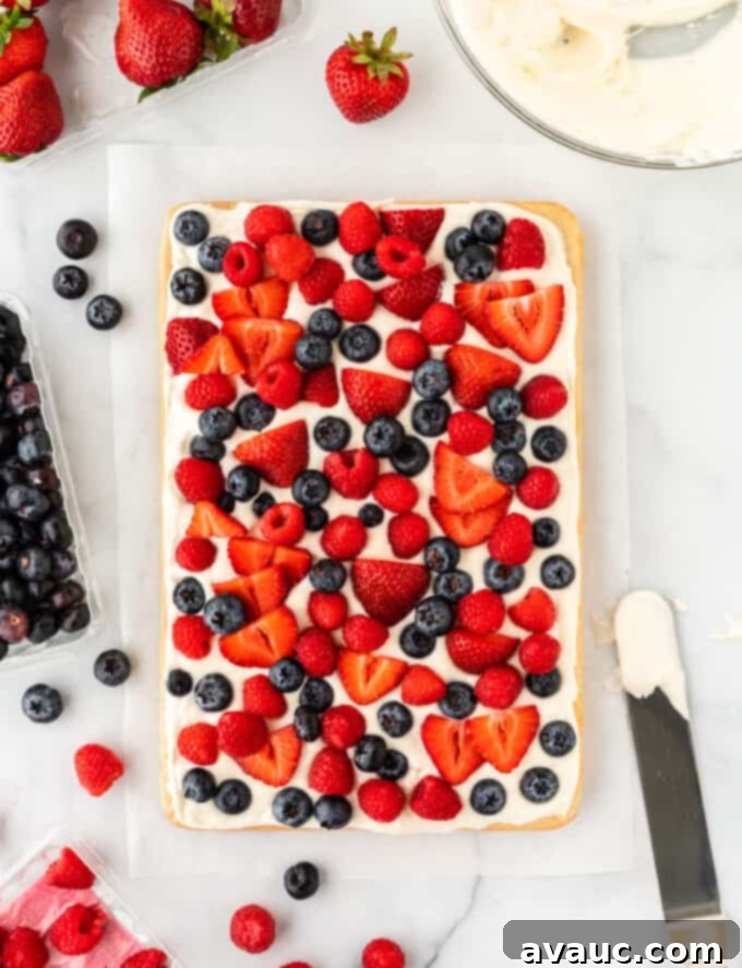 Sugar Cookie Fruit Pizza Bars 10 A freshly decorated sugar cookie fruit pizza, topped with cream cheese frosting and an abundance of fresh blueberries, strawberries, and raspberries.