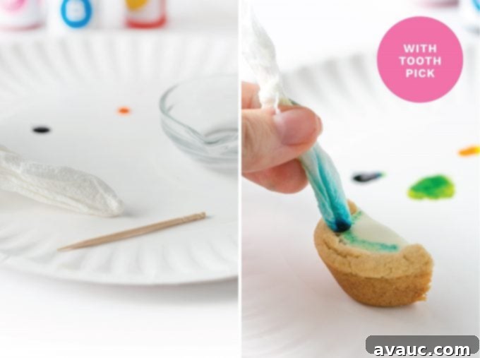 Another view of painting watermelon cookie cups, demonstrating the application of pink food coloring for the central 'flesh' part of the watermelon.