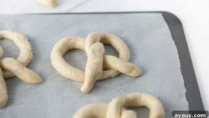 Twist pretzel dough into homemade soft pretzels for baking