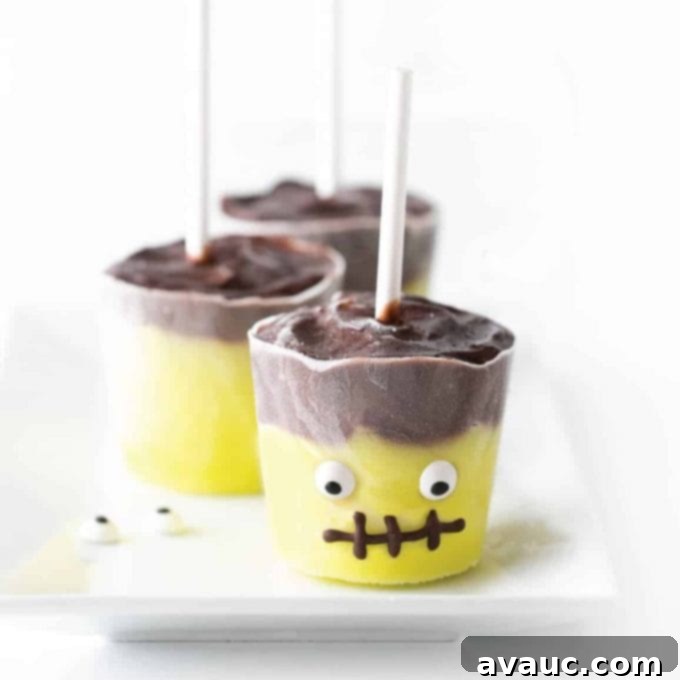 Frankenstein pudding pops with eyeballs and chocolate mouth.
