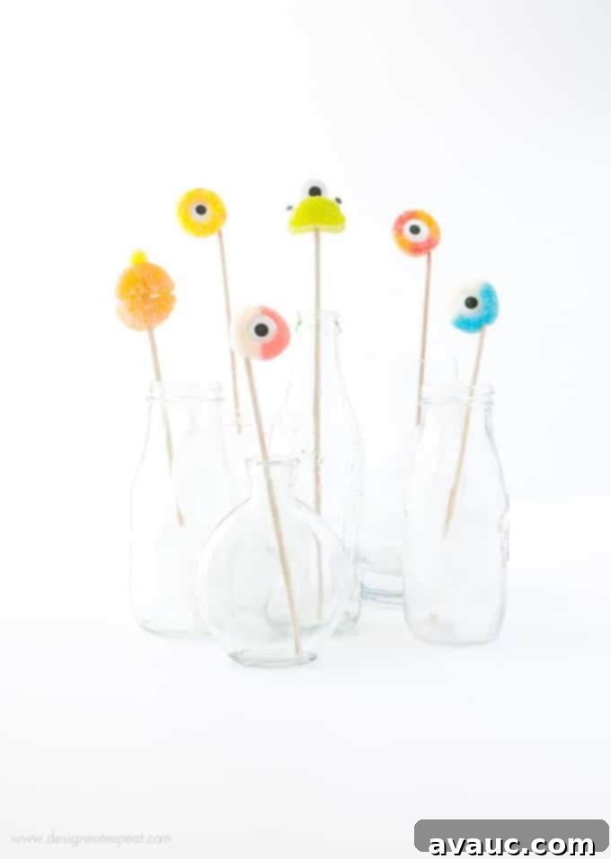 Colorful gummy candy rings on wooden skewers for halloween drink toppers
