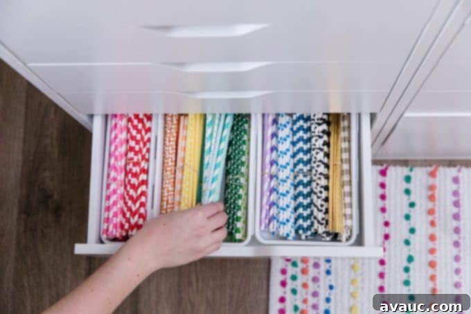 A drawer filled with colorful paper straws, neatly organized.