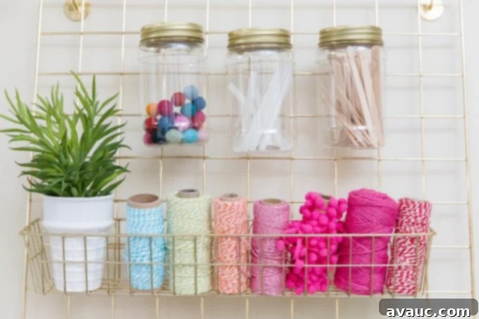 Wire wall hanger for ribbon, twine, and jars in a craft room setting.