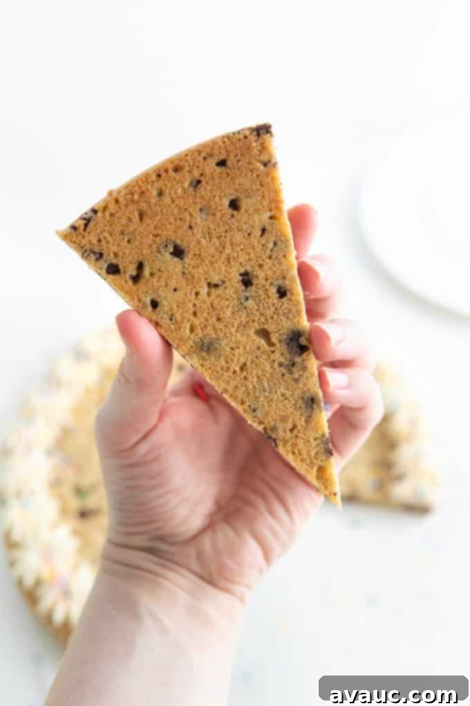 Close-up of cookie cake dough being pressed into a round baking pan