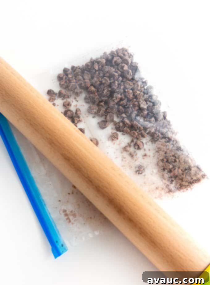 Chopping chocolate chips on a cutting board for the cookie cake dough