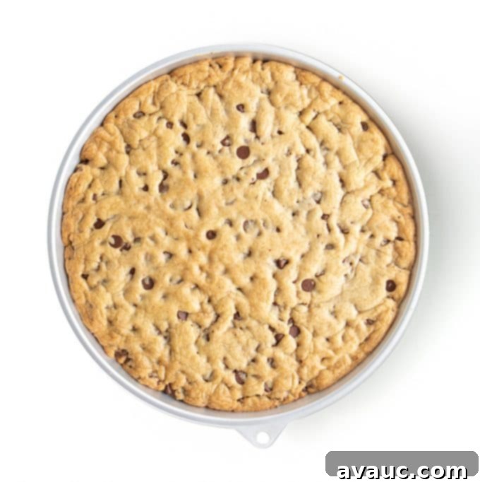 Golden brown homemade cookie cake cooling on a wire rack