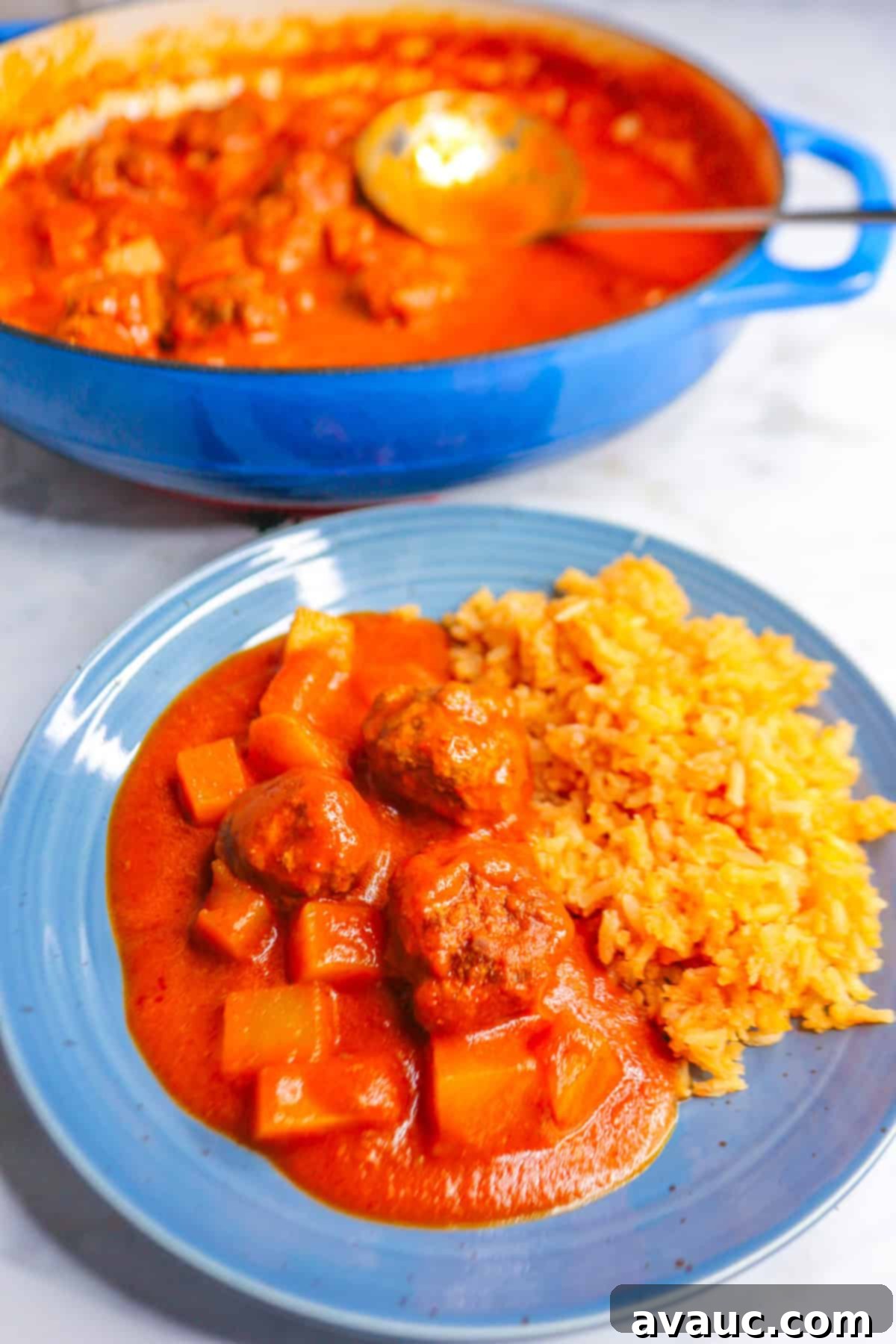 Albondigas in Chipotle Sauce on a plate with Mexican rice, a classic and comforting meal.