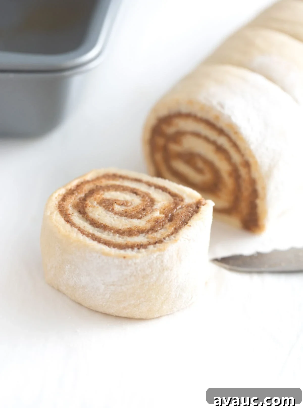 Close-up of a perfectly cut cinnamon roll swirl, showing filling layers