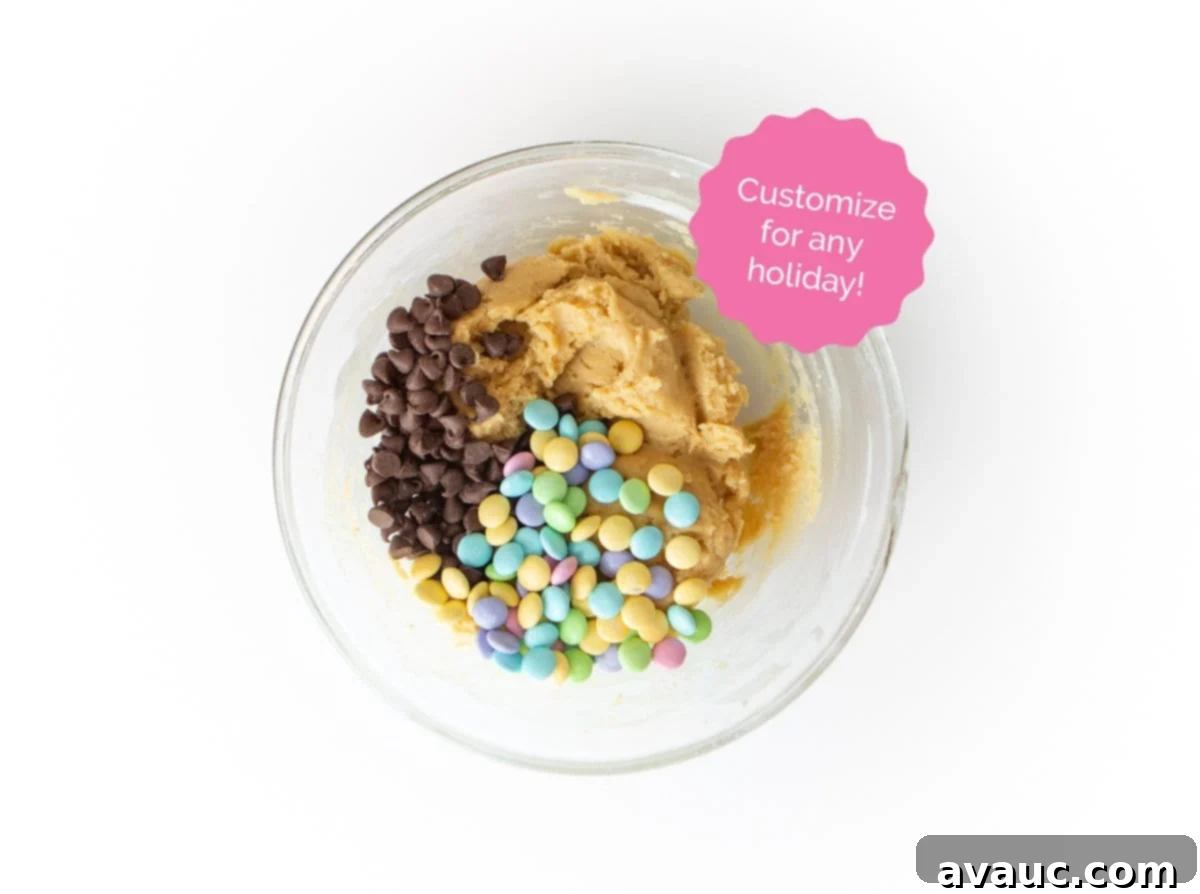 Colorful Chewy M and M Cookie Bars 11 Close-up of chocolate chip cookie dough mixed with pastel Easter M&M's in a bowl, ready for baking.