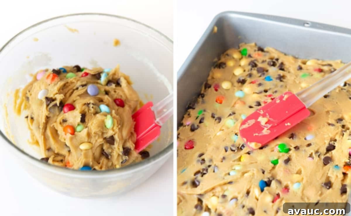 Colorful Chewy M and M Cookie Bars 6 Unbaked M&M cookie dough evenly pressed into a 9x13 inch baking pan, ready for the oven.