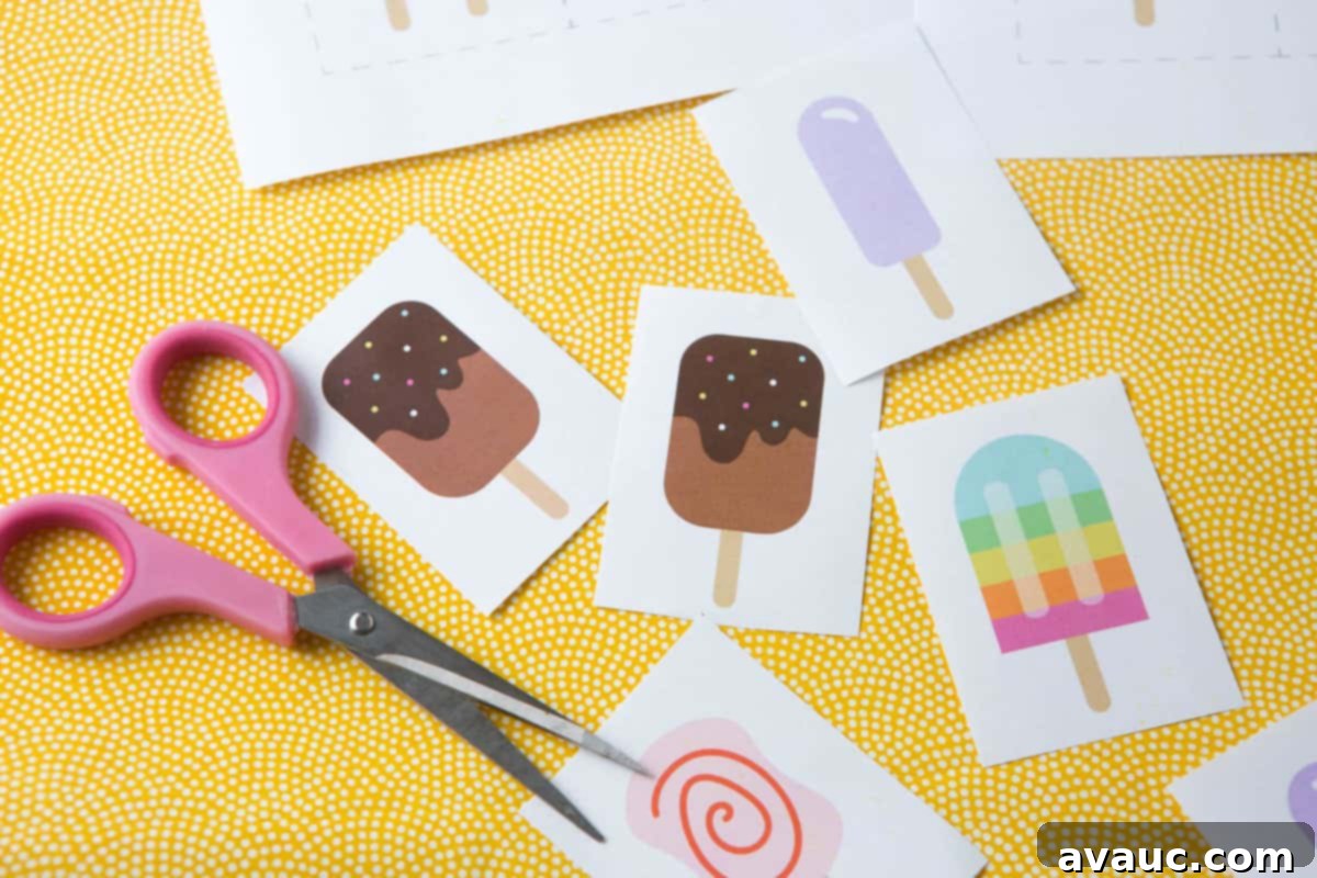 Ice Pop Memory Fun 6 Pink scissors cutting out individual popsicle printable memory cards from a sheet.