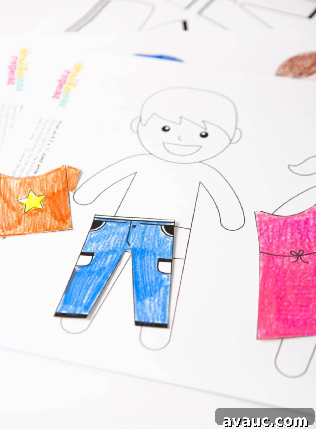 A child joyfully playing with laminated magnetic paper dolls and clothes on a blue cookie sheet