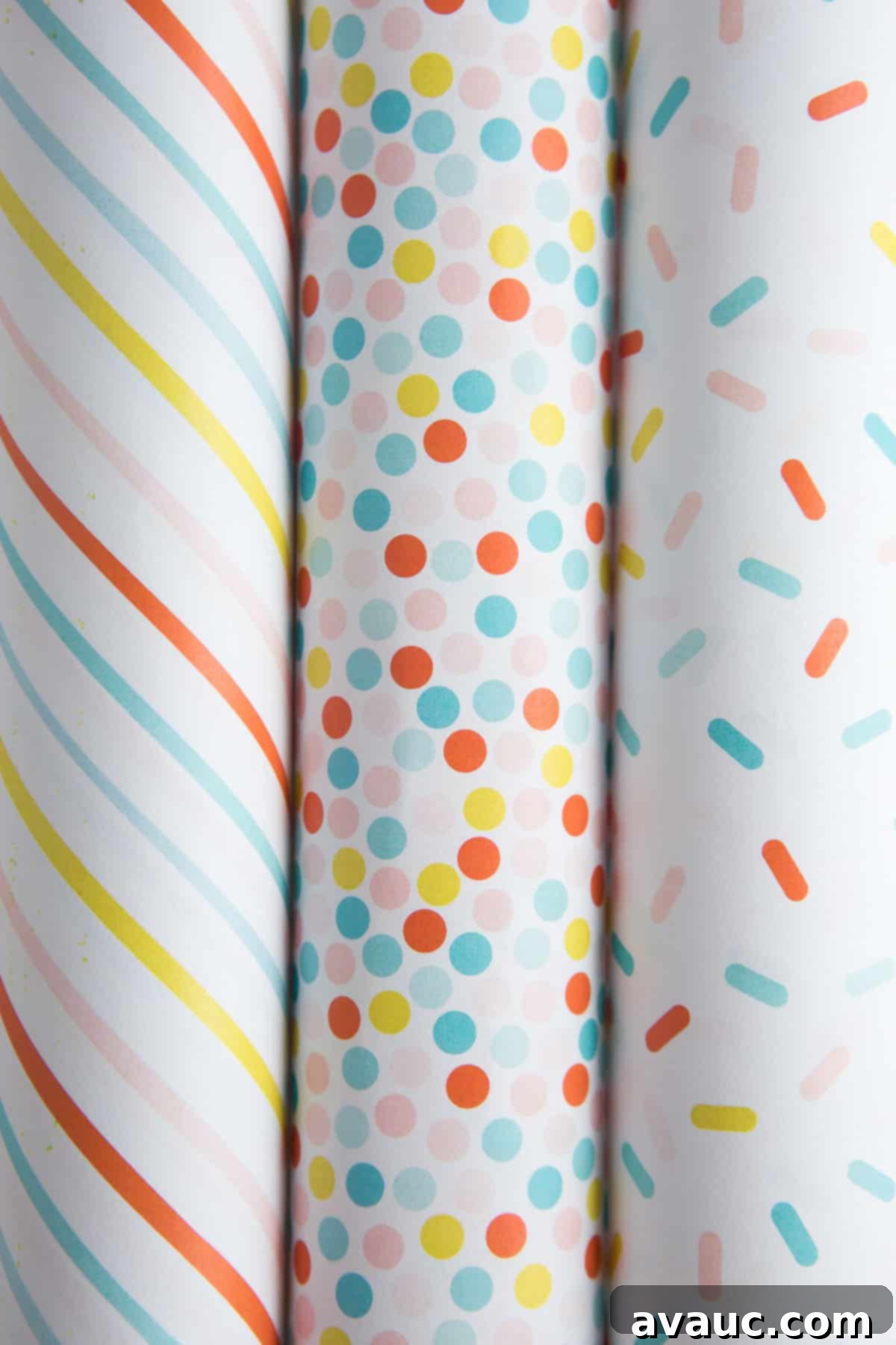 Free printable birthday wrapping paper patterns, including rainbow polka dot, sprinkle, and stripe designs, laid out on a table.