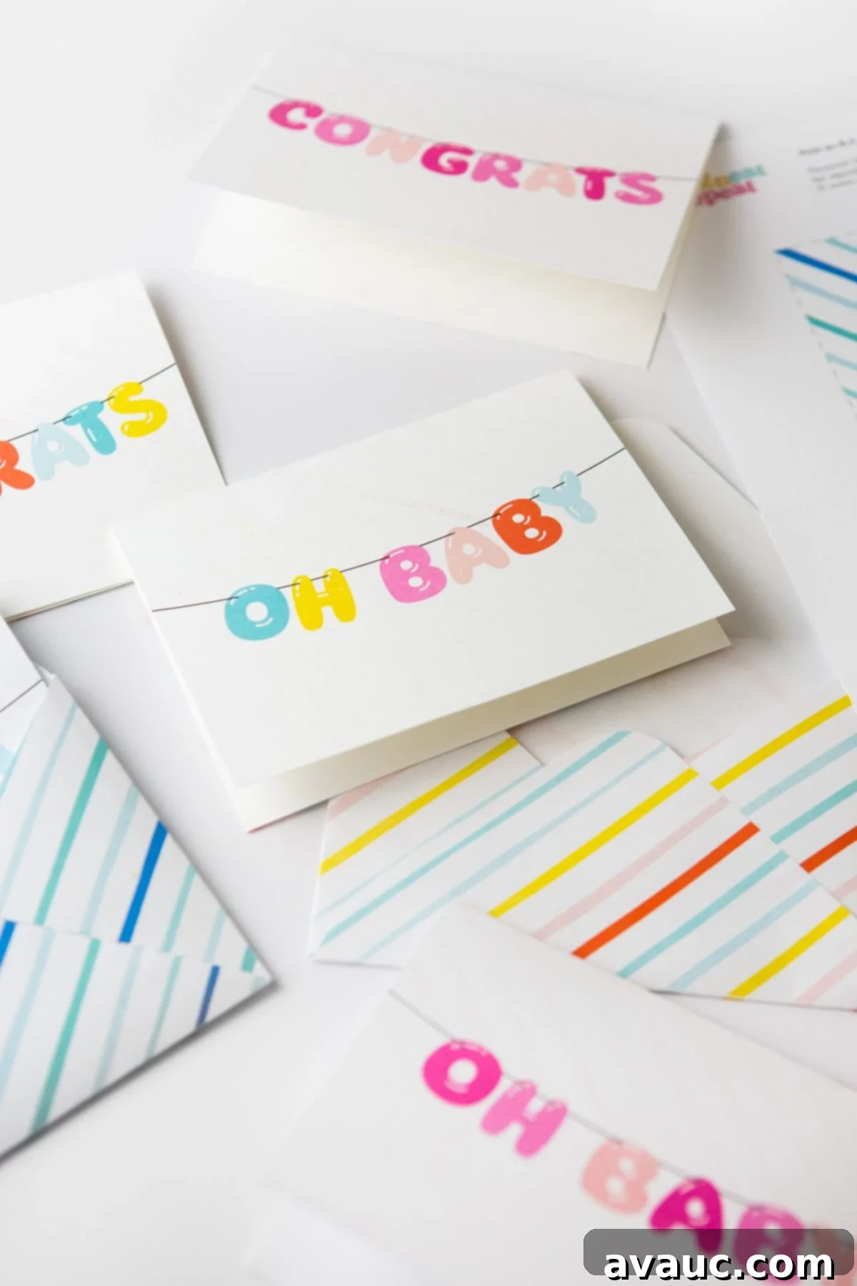 Collection of free printable congratulations baby cards in rainbow, pink, and blue designs, accompanied by matching envelopes.