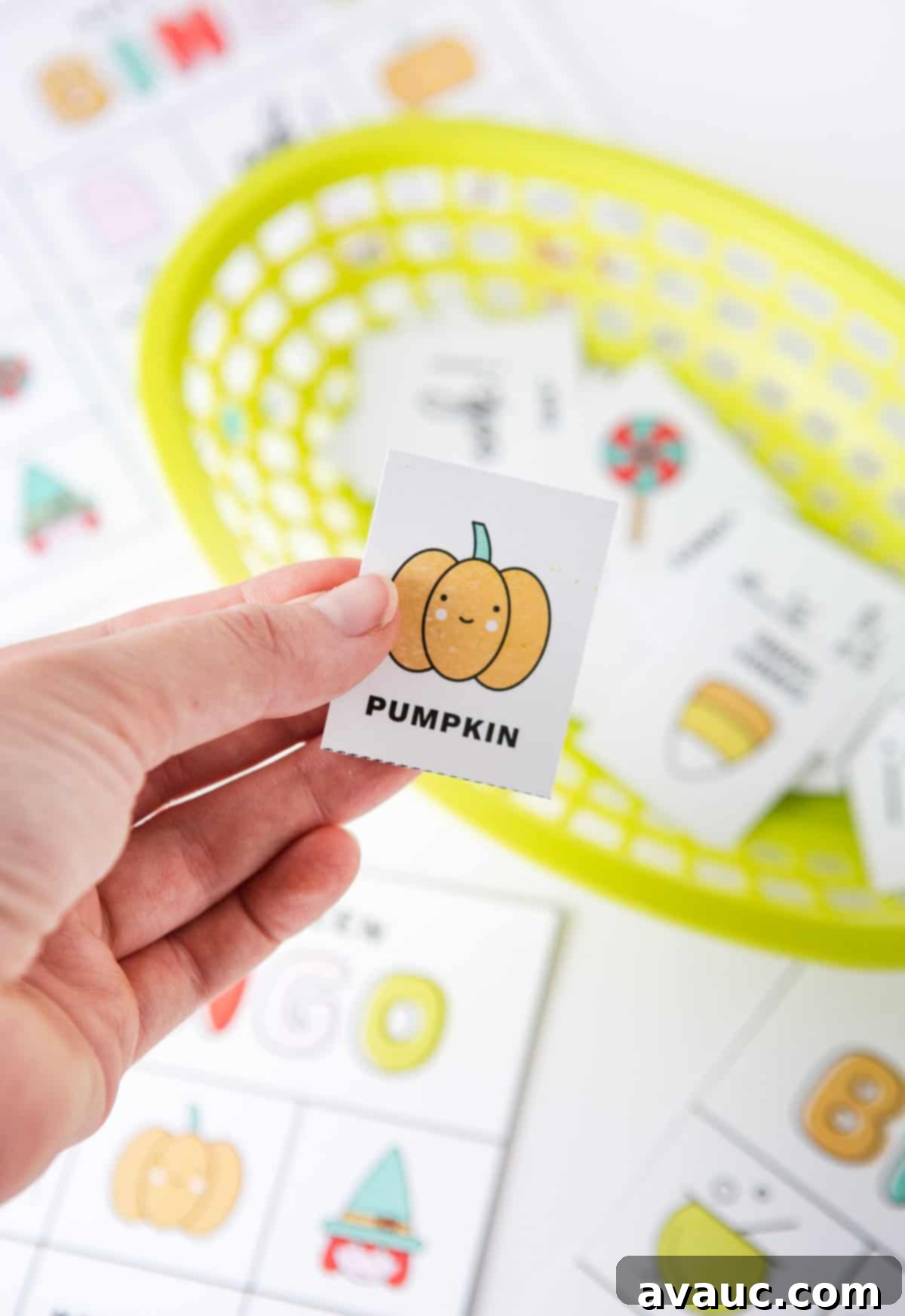 Spooktacular Halloween Bingo Fun 7 Hand holding pumpkin bingo card for Halloween bingo