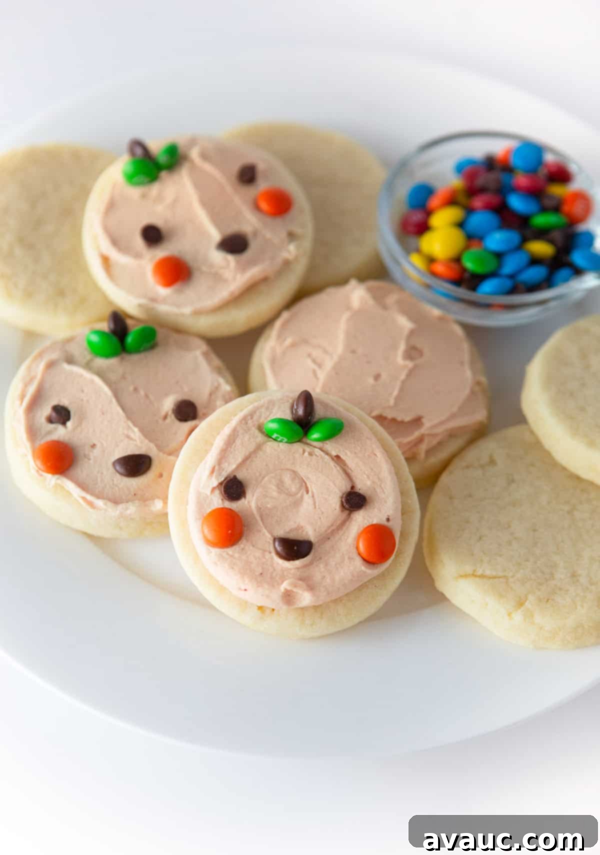 Spooktacularly Simple Pumpkin Cookies 2 Easy Halloween Pumpkin Cookies using cut out sugar cookies and mini M&M's for kid-friendly decorating