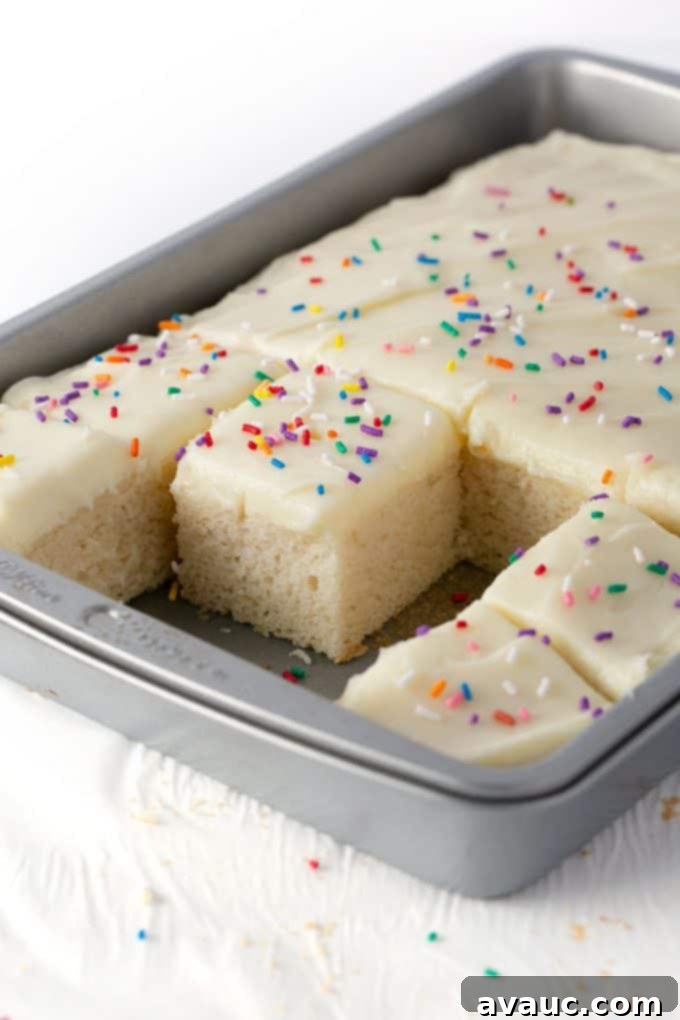 Perfect White Sheet Cake Box Mix Upgrade 2 white sheet cake in metal 9x13 pan with white frosting and sprinkles