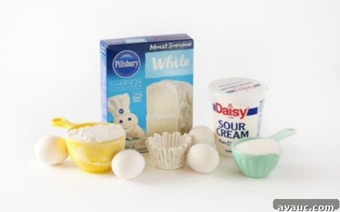 Perfect White Sheet Cake Box Mix Upgrade 4 ingredients for white cake mix, includes pillsbury white boxed cake mix, sour cream, eggs, sugar, flour, and cupcake liner