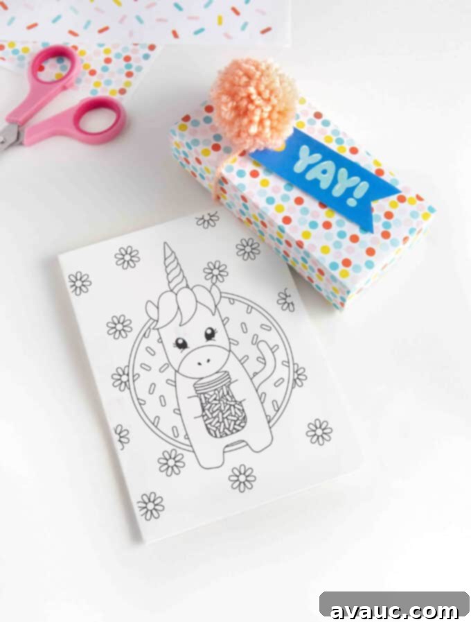 Magical Unicorn Birthday Printable 3 Printed 5x7 unicorn birthday card with colorful gift box, blue "YAY" gift tag, and pink pom pom, showcasing a perfect gift pairing.